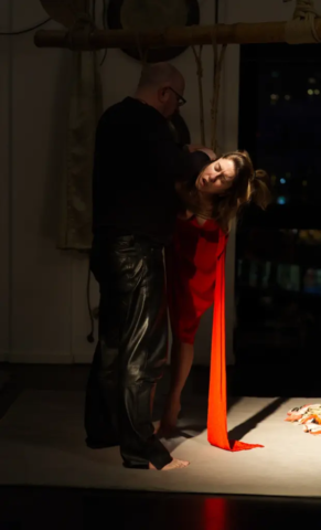 Visual representation of a Kinbaku Shibari Japanese Rope Bondage Performance by Alexander MA and Natasha NawaTaNeko in IKSK Berlin, Girl in red dress, sexpositive, conscious sexuality, couple