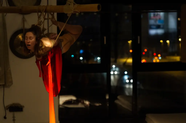 Visual representation of a Kinbaku Shibari Japanese Rope Bondage Performance by Alexander MA and Natasha NawaTaNeko in IKSK Berlin, Girl in red dress, sexpositive, conscious sexuality, couple