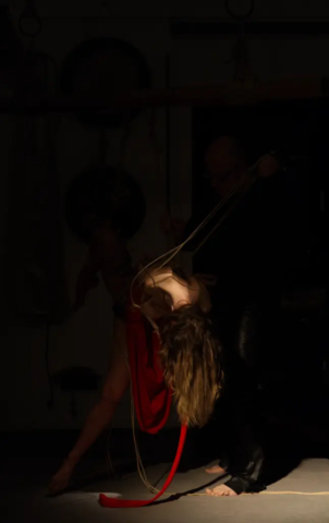 Visual representation of a Kinbaku Shibari Japanese Rope Bondage Performance by Alexander MA and Natasha NawaTaNeko in IKSK Berlin, Girl in red dress, sexpositive, conscious sexuality, couple