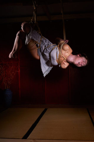 Pretty woman tied up in traditional Kinbaku Semenawa Shibari Rope Bondage.