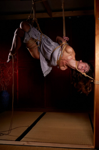Pretty woman tied up in traditional Kinbaku Semenawa Shibari Rope Bondage.
