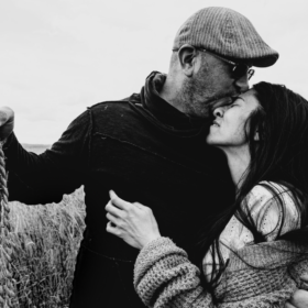 couple in the field man and woman intimacy hugging holding rice rope
