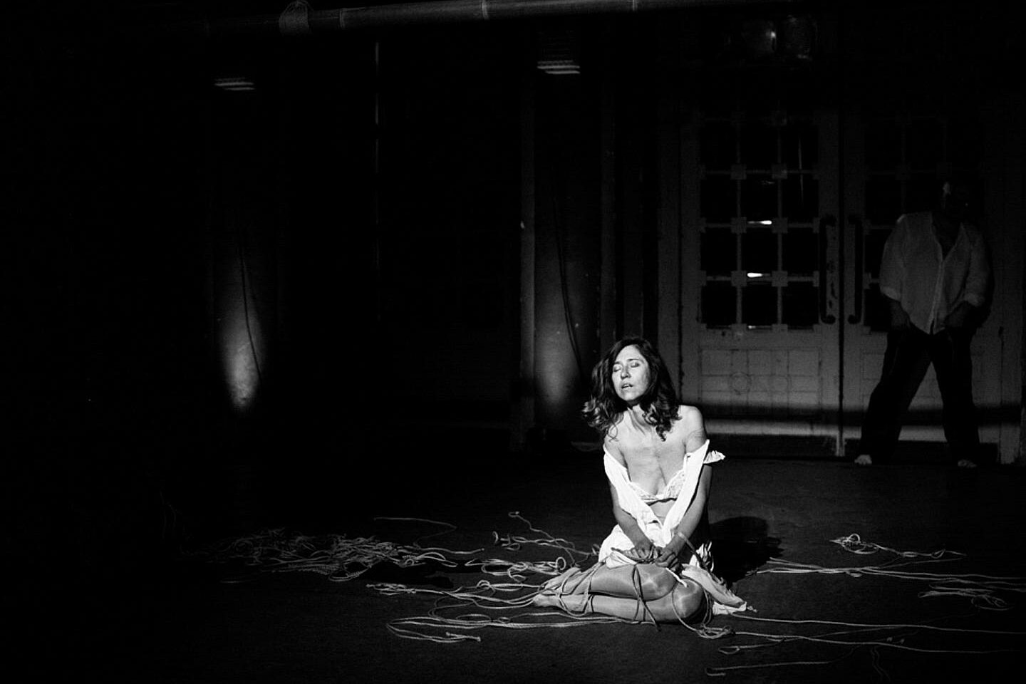 black and white picture of the performance lonely girl on stage conveying feeling of abandonment